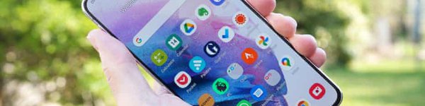 image of a hand showing a mobile phone displaying a variety of apps